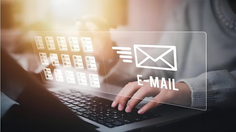Hands on a laptop with a floating email icon interface.